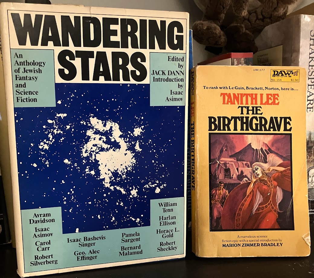 a paperback copy of Tanith Lee's The Birthgrave alongside a hardcover of the anthology Wandering Stars 